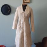 Penhoar vintage Valisere anos 70 em matelassê off white, com botões frontais e gola ampla, exibido em manequim